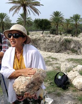 Dr. Norma Franklin holding a mud-brick from the Solomonic period