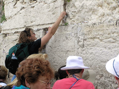 Tucking a prayer request into the Western Wall Putting a prayer request into the Western Wall